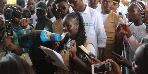 Alfrea Toe of JOCSAI reads the petition.